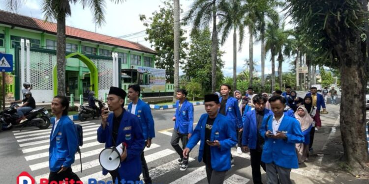 PMII Pacitan saat berjalan menuju Kantor Dinas Sosial Kabupaten Pacitan untuk menyampaikan enam tuntutan terkait pembenahan penyaluran bantuan sosial, Senin, 17 November 2025. (Foto: Sunardi/Berita Pacitan).